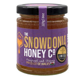 Jar of Snowdonia Honey Co. honey with purple label on a white background